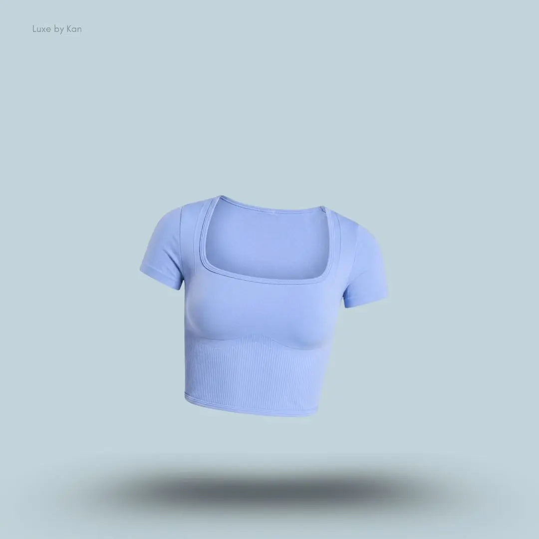 Gymshark x Bratz Crop Top in steady purple displayed on a blue background with a body-fit cropped design