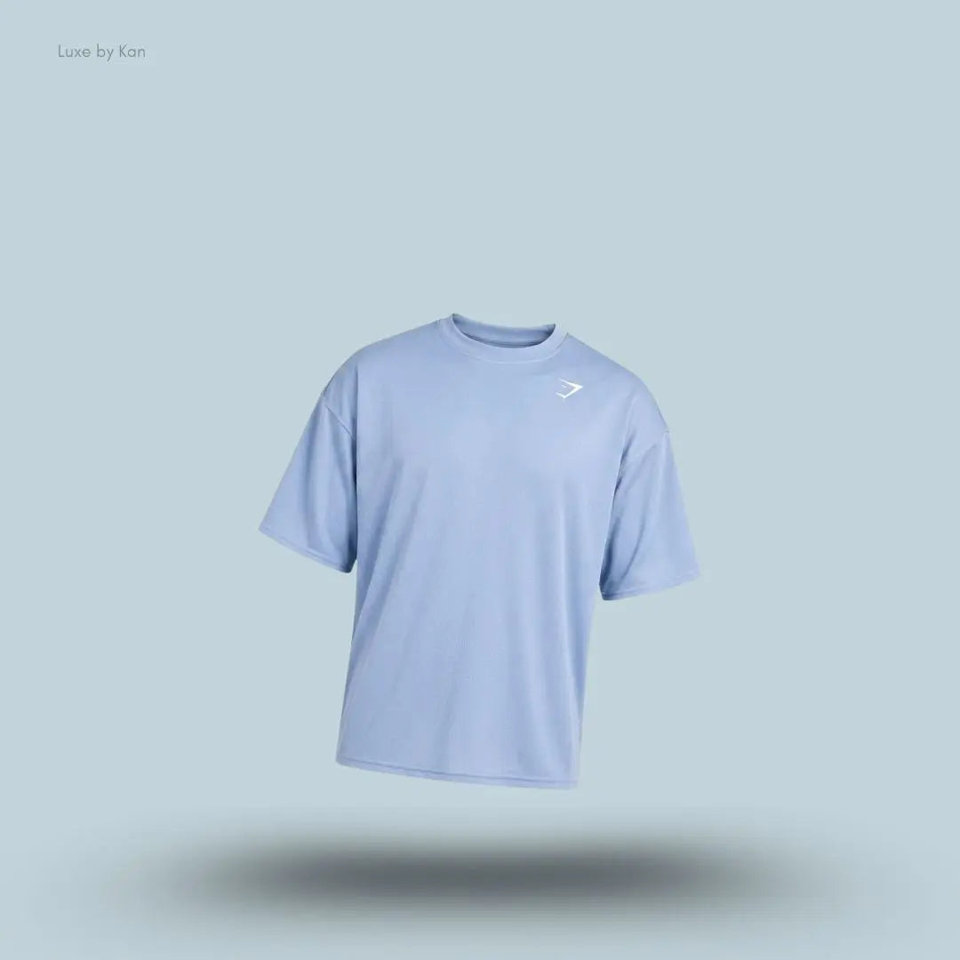 Gymshark Washed Pastels T-Shirt in purple displayed on a blue background with an oversized short-sleeve design