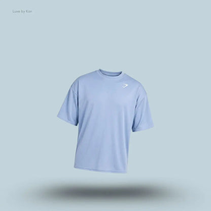 Gymshark Washed Pastels T-Shirt in purple displayed on a blue background with an oversized short-sleeve design