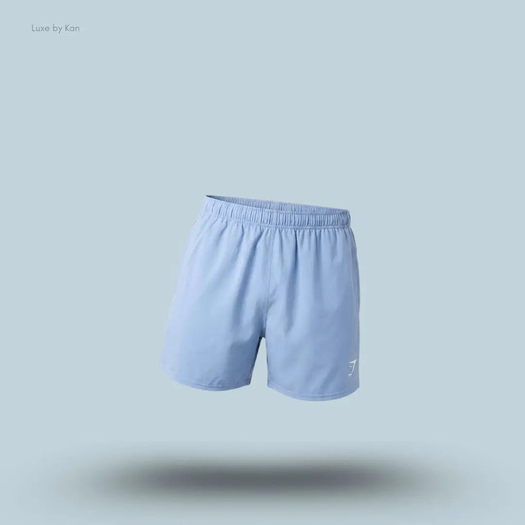 Gymshark Washed Pastels Shorts in purple displayed on a blue background with a relaxed athletic shorts design