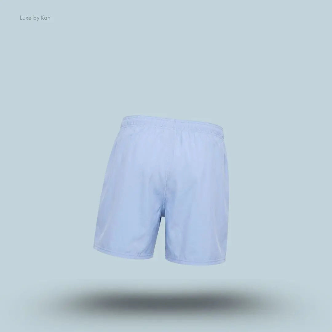 Gymshark Washed Pastels Shorts in purple displayed on a blue background with a relaxed athletic shorts design back view