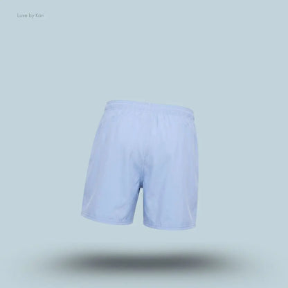 Gymshark Washed Pastels Shorts in purple displayed on a blue background with a relaxed athletic shorts design back view