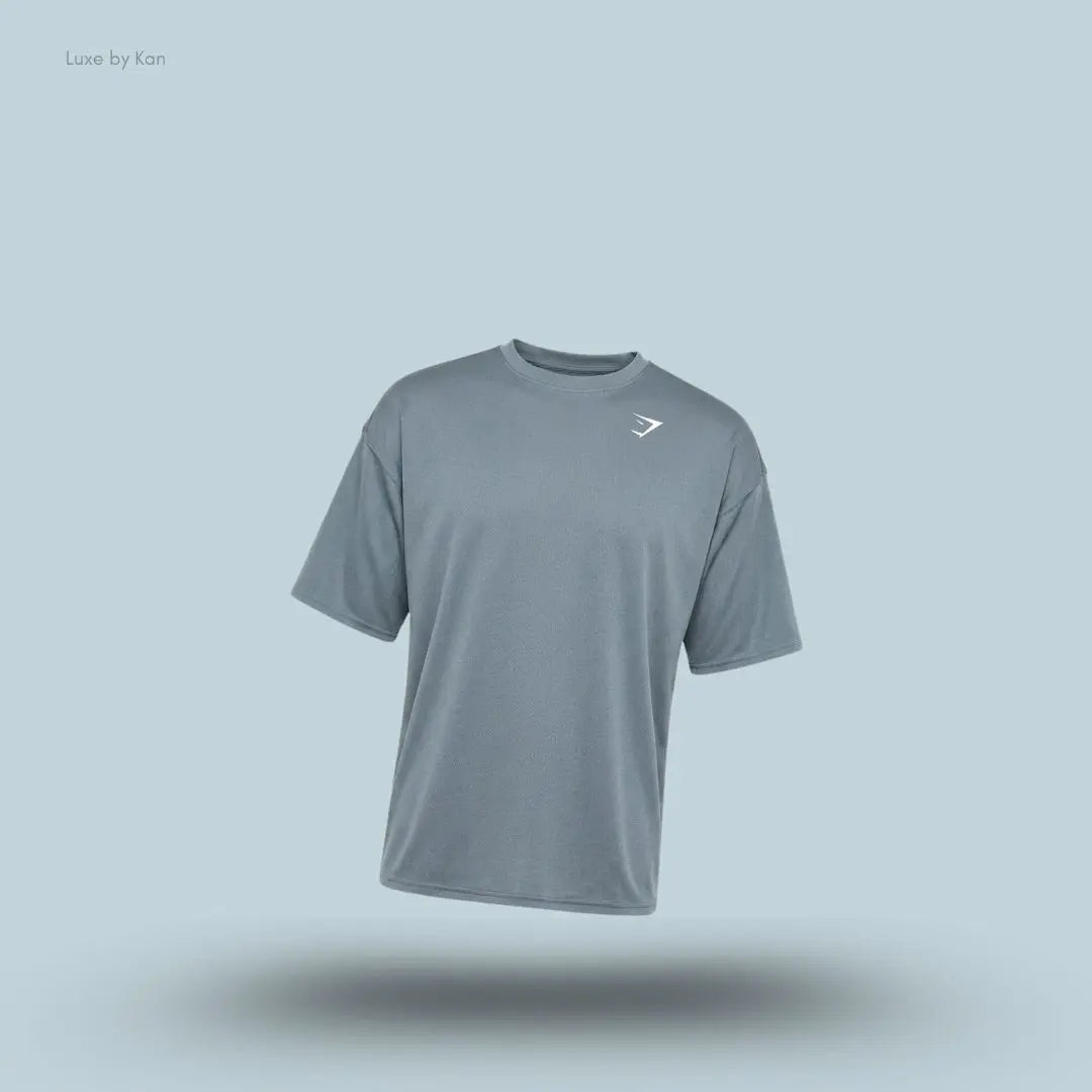 Gymshark Washed Pastels T-Shirt in stealth blue displayed on a blue background with an oversized short-sleeve design