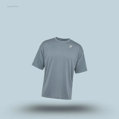 Gymshark Washed Pastels T-Shirt in stealth blue displayed on a blue background with an oversized short-sleeve design