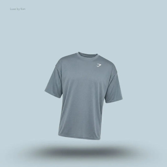 Gymshark Washed Pastels T-Shirt in stealth blue displayed on a blue background with an oversized short-sleeve design