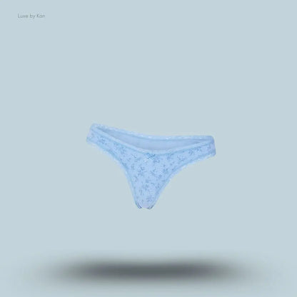 SKIMS Lightweight Cotton Lace Thong in Surf Dainty Floral Print, flat lay on light blue background