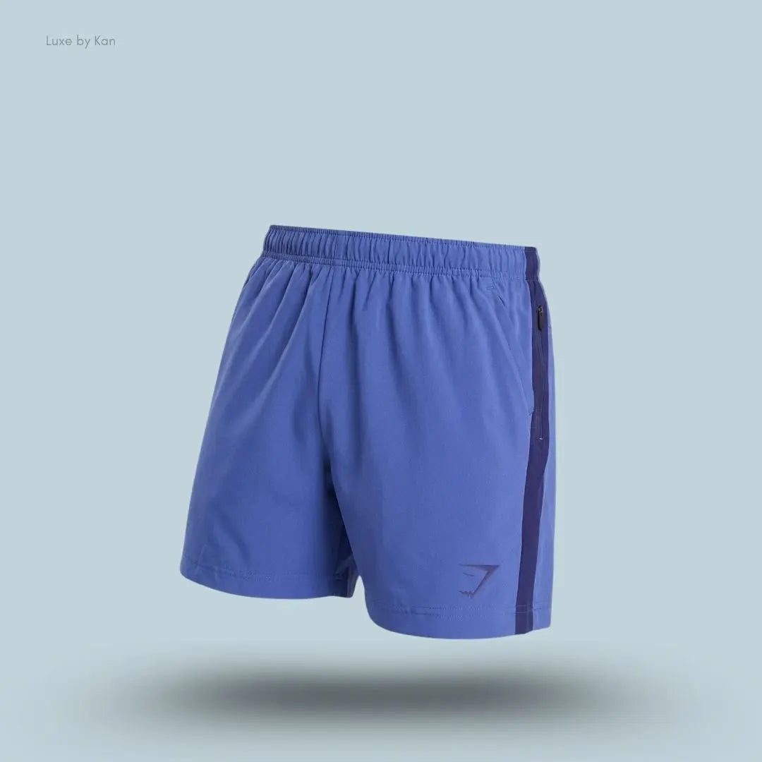 Gymshark Sport 5" Shorts men's slim-fit training shorts in blue with contrast side panels on a blue background