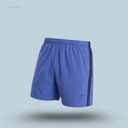 Gymshark Sport 5" Shorts men's slim-fit training shorts in blue with contrast side panels on a blue background