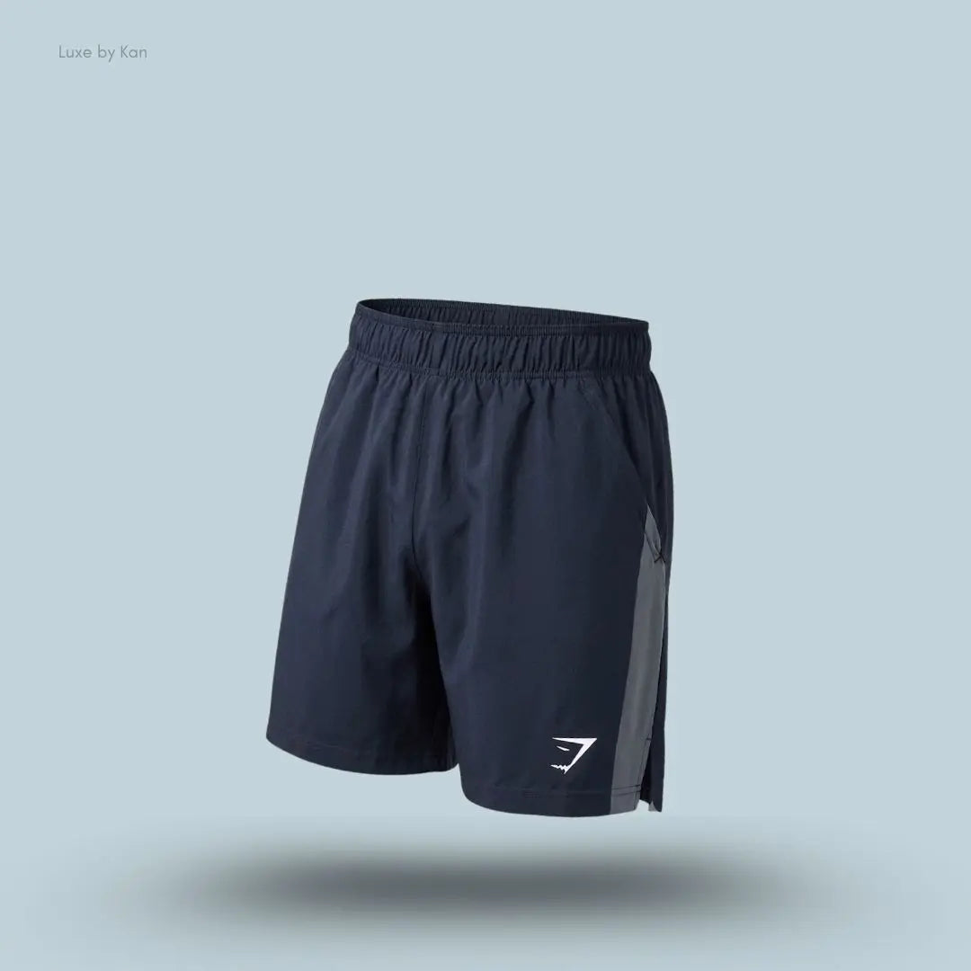 Gymshark Sport 7" Shorts in dark blue with contrast side panels on a blue background