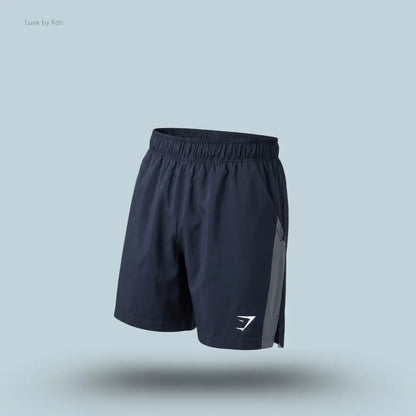 Gymshark Sport 7" Shorts in dark blue with contrast side panels on a blue background