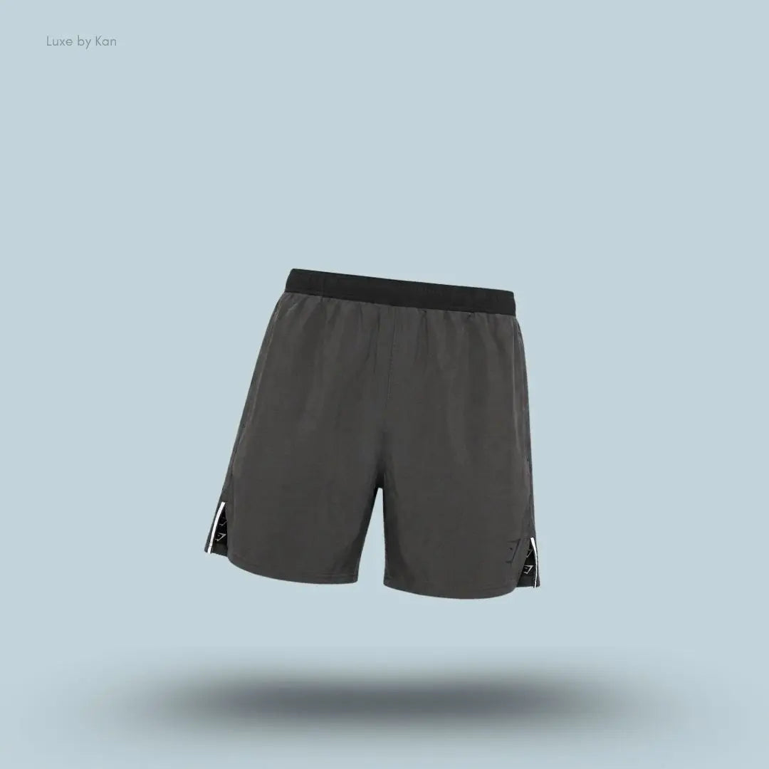 Gymshark Arrival Contrast Shorts in grey displayed on a blue background with a slim-fit athletic shorts design