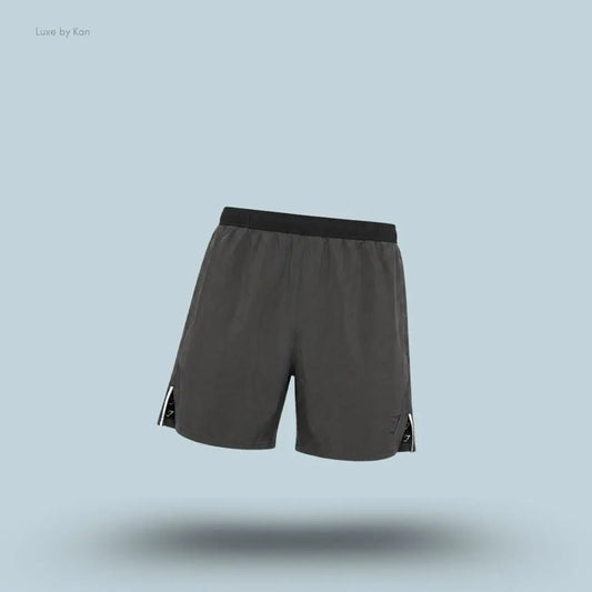 Gymshark Arrival Contrast Shorts in grey displayed on a blue background with a slim-fit athletic shorts design