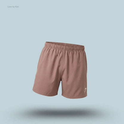 Gymshark Washed Pastels Shorts in brown displayed on a blue background with a relaxed athletic shorts design