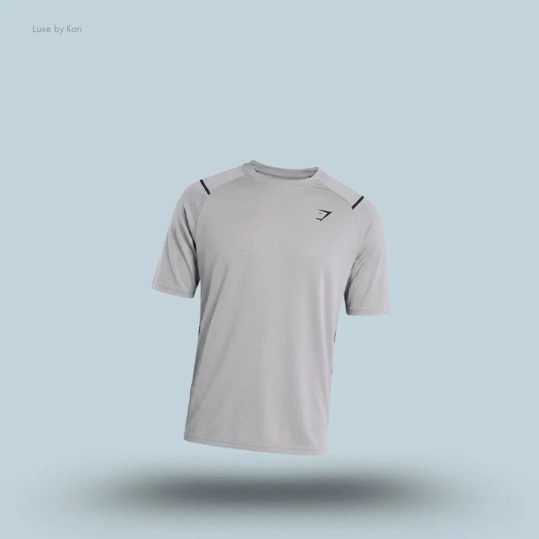 Gymshark Arrival Contrast T-Shirt in light grey displayed on a blue background with contrast shoulder piping and short sleeves