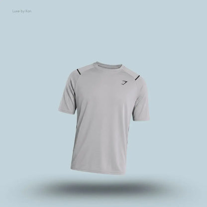 Gymshark Arrival Contrast T-Shirt in light grey displayed on a blue background with contrast shoulder piping and short sleeves