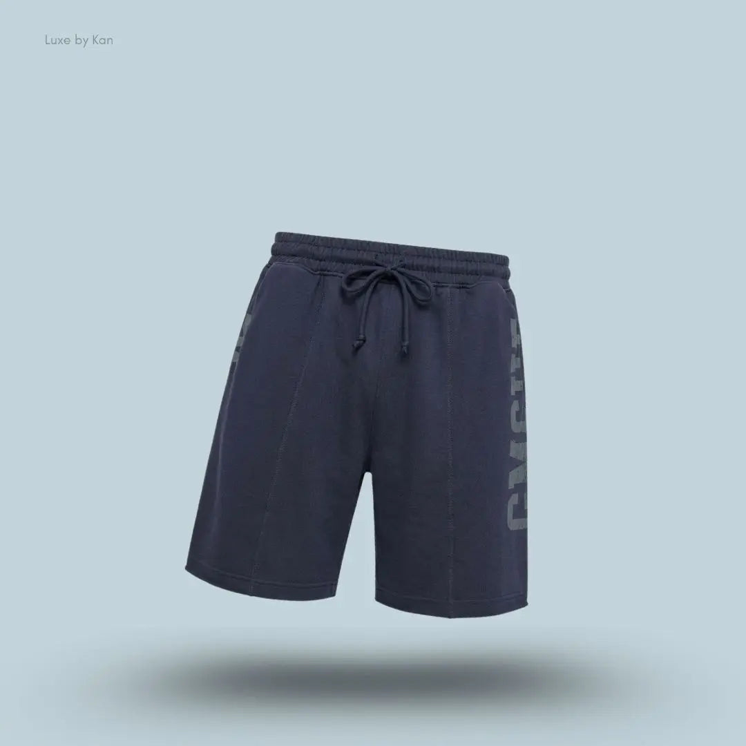 Gymshark Accent Graphic Sweat Shorts in heavy blue displayed on a blue background with an oversized fit and raw hem design