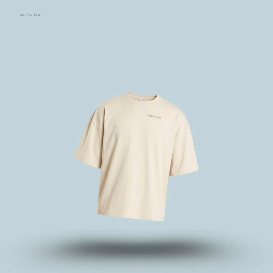 Gymshark Accent Boxy T-Shirt in tinted white displayed on a blue background with an oversized boxy short-sleeve design