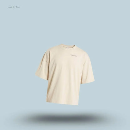 Gymshark Accent Boxy T-Shirt in tinted white displayed on a blue background with an oversized boxy short-sleeve design