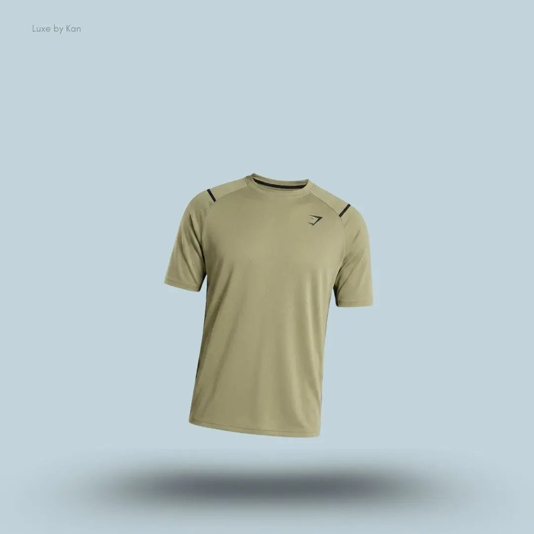 Gymshark Arrival Contrast T-Shirt in light olive displayed on a blue background with contrast shoulder piping and short sleeves