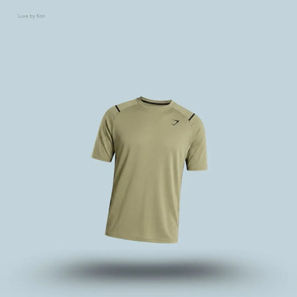 Gymshark Arrival Contrast T-Shirt in light olive displayed on a blue background with contrast shoulder piping and short sleeves