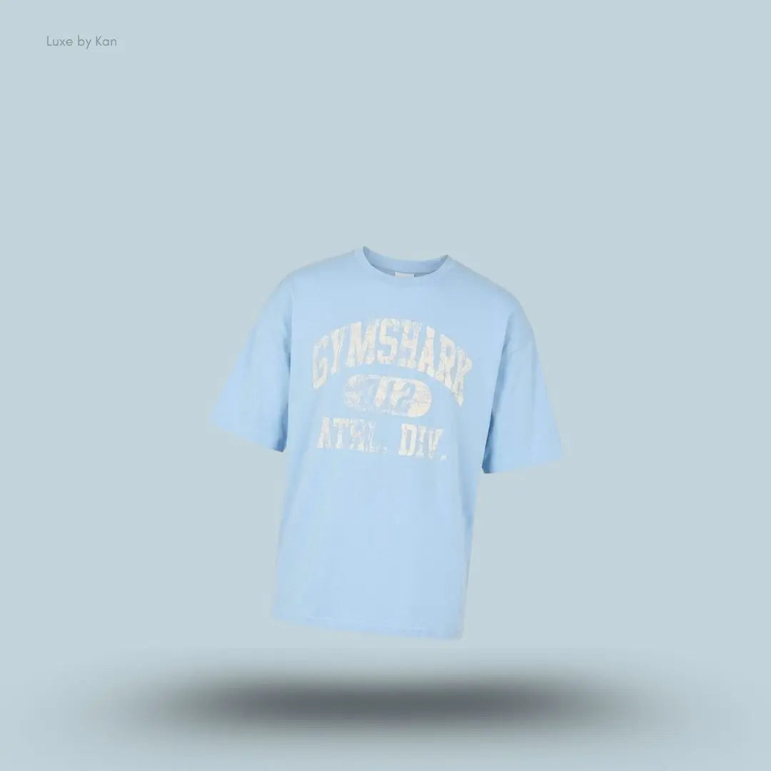 Gymshark Athletic Division Graphic T-Shirt in light blue with front graphic print on a blue background