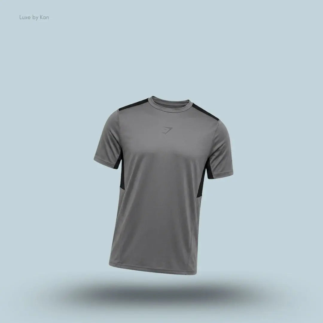 gymshark Sport T-Shirt in dark grey with short sleeves and front logo, men's slim-fit performance training tee on blue background.