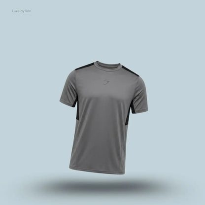 gymshark Sport T-Shirt in dark grey with short sleeves and front logo, men's slim-fit performance training tee on blue background.