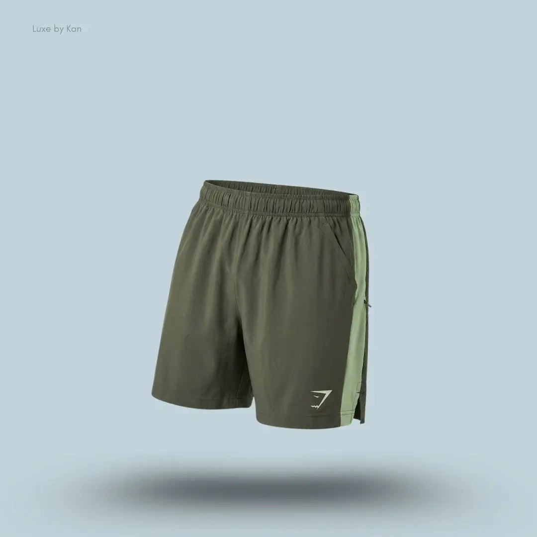 Gymshark Sport 7" Shorts in olive green with contrast side panels on a blue background