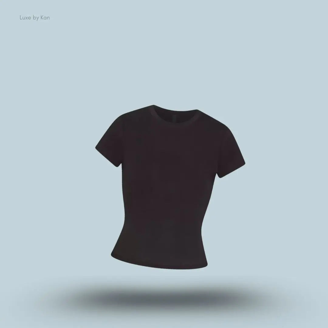 SKIMS Worn In Jersey T-Shirt in Washed Onyx, flat lay on light blue background