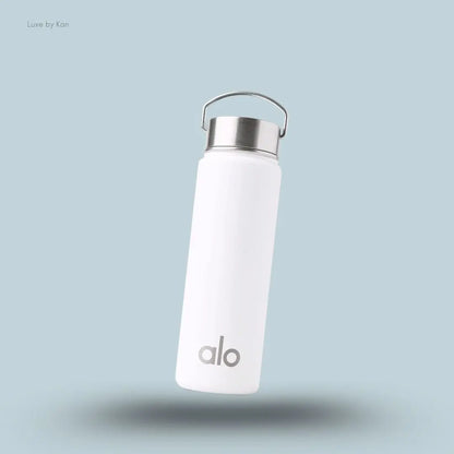 Alo Water Bottle in White, flat lay on light blue background