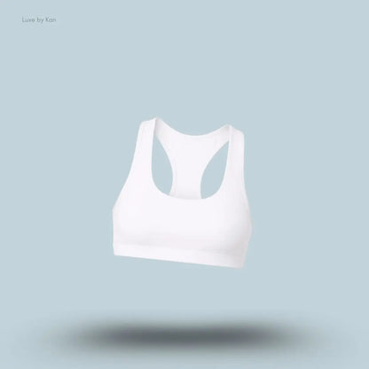 Alo Airlift Advantage Racerback Bra in White, flat lay on light blue background