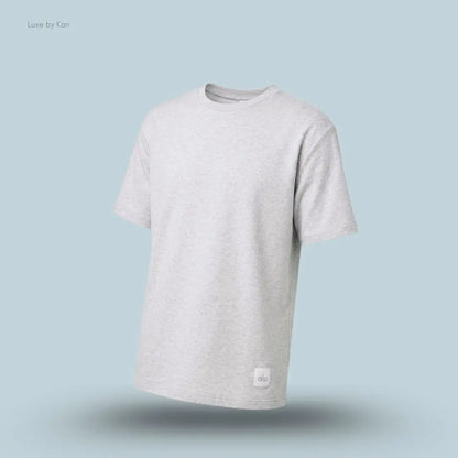 Alo Double Take Short Sleeve in White Heather, flat lay on light blue background