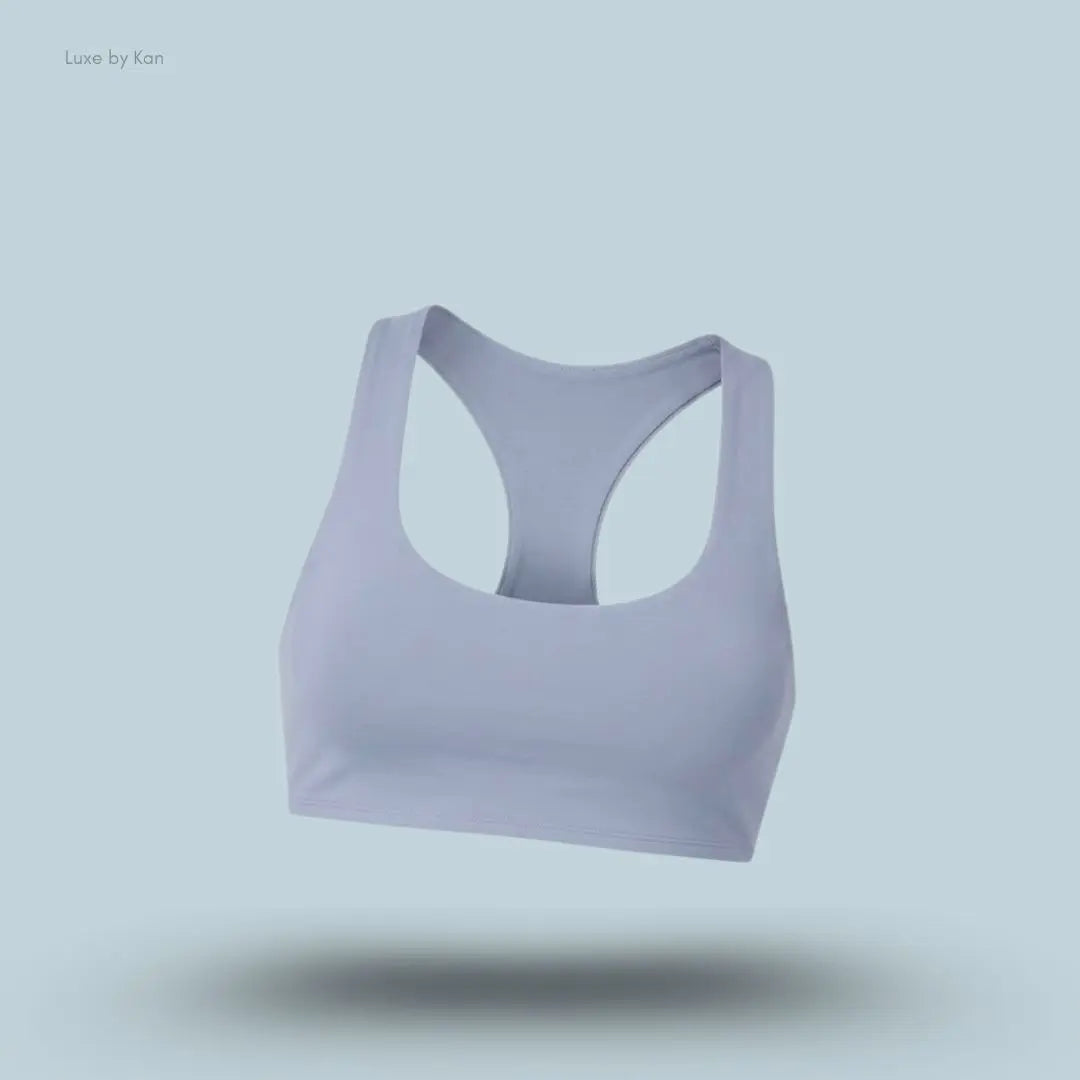 Alo Airlift Advantage Racerback Bra in Winter Frost, flat lay on light blue background