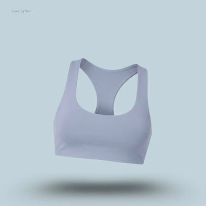Alo Airlift Advantage Racerback Bra in Winter Frost, flat lay on light blue background