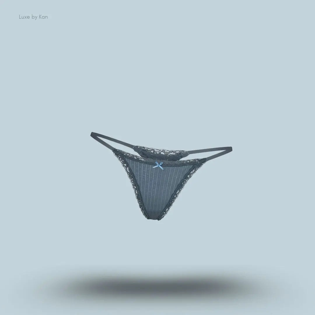 SKIMS Lightweight Cotton Pointelle Lace String Thong in Zircon Tonal, flat lay on light blue background