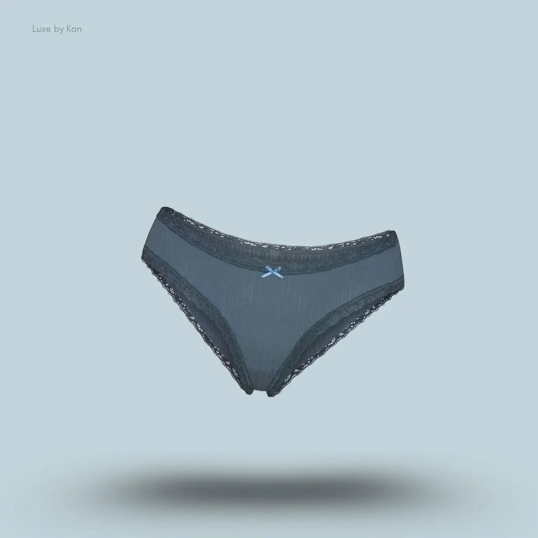 SKIMS Lightweight Cotton Pointelle Lace Brief in Zircon Tonal, flat lay on light blue background